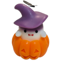 Little Witch candle: ivory ghost in a plum witch hat inside an orange jack-o'-lantern